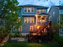 Backyard view with a spacious patio, grill, and stairs leading to a screened porch at 725 Ancient Oaks Dr, Holly Springs, NC 27540