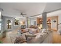 Spacious living room featuring a comfortable sectional sofa, ceiling fan, and lots of natural light at 725 Ancient Oaks Dr, Holly Springs, NC 27540