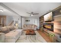 Spacious living room with wood accent wall, fireplace, and ceiling fan at 725 Ancient Oaks Dr, Holly Springs, NC 27540