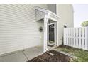 Charming entryway with decorative black door and adjacent white picket fence at 7528 Argent Valley Dr, Raleigh, NC 27616