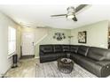 Cozy living room with plush L-shaped sofa, ceiling fan and natural light at 7528 Argent Valley Dr, Raleigh, NC 27616