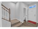 Bright foyer with staircase, hardwood floors, and a convenient powder room at 8601 Red Canyon Way, Raleigh, NC 27616
