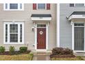 Close up of the front door featuring stylish details and manicured landscaping around the entrance at 8601 Red Canyon Way, Raleigh, NC 27616