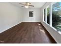 Bright living room featuring dark wood floors and large windows at 901 Forge Rd, Durham, NC 27713