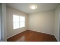 Bright bedroom with a large window offering plenty of natural light and hardwood floors at 910 Cedar Creek Dr, Wendell, NC 27591