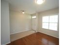 Entryway leading to the living room, featuring hardwood floors, carpet and a white front door at 910 Cedar Creek Dr, Wendell, NC 27591