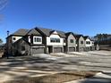 Row of townhomes with neutral exteriors, stone accents, attached garages, and well-maintained landscaping at 964 Double Helix Rd, Apex, NC 27523
