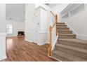 Spacious foyer with hardwood floors, staircase, and access to the living room at 1012 Trail Stream Way, Knightdale, NC 27545