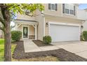 Close-up of the home's entrance, featuring a decorative door and a two-car garage at 104 Rosebud Ln, Durham, NC 27704