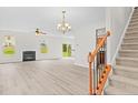 Spacious living room with fireplace, wood-look floors, and lots of natural light at 104 Rosebud Ln, Durham, NC 27704