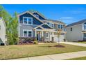 Charming two-story home with a two-car garage and professionally landscaped front yard at 105 Scoville Rd, Garner, NC 27529