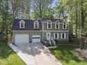 Traditional-style home features a two-car garage, dormer windows, and a well-manicured lawn at 108 Ridgepath Way, Cary, NC 27511