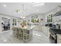 Bright kitchen features a large island with seating, granite countertops, and stainless steel appliances at 108 Ridgepath Way, Cary, NC 27511