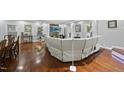 Spacious living room with hardwood floors, brick fireplace, and large sectional sofa at 108 Ridgepath Way, Cary, NC 27511
