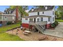 This home features an outdoor deck, play area, seating, picnic table, and a well-manicured lawn at 116 W Front St, Oxford, NC 27565