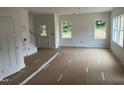 Spacious living room featuring natural light from three windows and a door to the outside at 12 Gates St, Roxboro, NC 27573