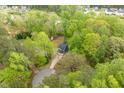 Scenic aerial view of a charming home nestled among lush green trees at 120 Kerigon Ln, Youngsville, NC 27596