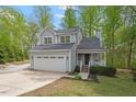 Charming two-story home with a well-maintained front yard, large garage, and inviting front porch at 120 Kerigon Ln, Youngsville, NC 27596