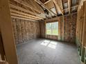 Unfinished bedroom with a window provides natural light, highlighting the space's construction phase at 125 Tee Dr, Selma, NC 27576