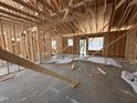 Interior view showcases the framing of a house, highlighting the structure and window placement during construction at 125 Tee Dr, Selma, NC 27576