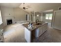 Modern kitchen featuring a sink in the island, and views into the fireplace at 125 Tee Dr, Selma, NC 27576
