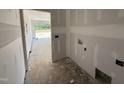Unfinished laundry room with visible electrical and plumbing hookups, offering a functional space at 125 Tee Dr, Selma, NC 27576