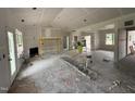 Bright living room with high ceilings, a fireplace, and a large window offering a view to the outside at 125 Tee Dr, Selma, NC 27576