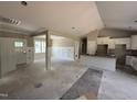 Spacious living room open to the kitchen featuring white wainscotting and lots of natural light at 125 Tee Dr, Selma, NC 27576