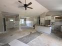 Spacious living room with white wainscoting and views into kitchen with island at 125 Tee Dr, Selma, NC 27576