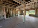 Unfinished living room revealing the frame and insulation, awaiting personalized touches and design at 125 Tee Dr, Selma, NC 27576