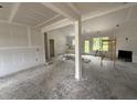 Spacious living room featuring unfinished walls, door to the backyard, and a cozy fireplace under construction at 125 Tee Dr, Selma, NC 27576