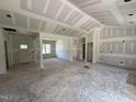 Unfinished open-concept living area with visible framing and abundant natural light from a large window at 125 Tee Dr, Selma, NC 27576