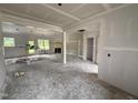 Open living room with large windows, unfinished walls, awaiting transformation into a welcoming space at 125 Tee Dr, Selma, NC 27576