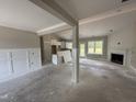 Open concept living room features a fireplace, modern wainscotting and outdoor access at 125 Tee Dr, Selma, NC 27576