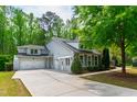 Spacious home featuring a three-car garage, ample parking, and a professionally landscaped yard with mature trees at 12833 Edsel Dr, Raleigh, NC 27613
