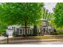 Beautiful home with a three-car garage, well-maintained lawn, and professionally landscaped front yard at 12833 Edsel Dr, Raleigh, NC 27613