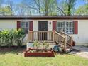 Close-up of the entrance with a small wooden porch and charming decorative touches at 1301 Lynnwood Rd, Knightdale, NC 27545