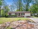 Cozy single-story home featuring red shutters and a well-manicured lawn at 1301 Lynnwood Rd, Knightdale, NC 27545