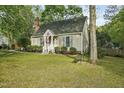 View of home featuring tidy landscaping, side bench, and American Flag at 13816 N Meadows Ct, Wake Forest, NC 27587