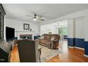 Open-concept living room and dining area featuring a fireplace and hardwood floors at 13816 N Meadows Ct, Wake Forest, NC 27587