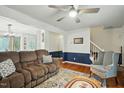 View of a cozy living room with a ceiling fan and hardwood floors at 13816 N Meadows Ct, Wake Forest, NC 27587