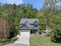 An elevated view of a two-story home with a two-car garage, driveway, and landscaping at 1401 Freshwater Ct, Wake Forest, NC 27587