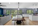 Bright, open-concept living space featuring sleek floors, modern lighting, and views of the surrounding landscape at 1401 Freshwater Ct, Wake Forest, NC 27587