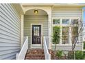 Close-up of the home's entrance with brick stairs and porch at 1433 Deltona Dr, Raleigh, NC 27615