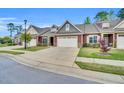 Street view of homes featuring two-car garages, stone accents and manicured lawns at 153 Telluride Trl, Garner, NC 27529