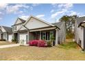 Attractive home with gray siding, stone details, front porch and a red door at 178 Cullen Ct, Clayton, NC 27520