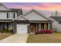 Charming home featuring gray siding, stone accents, a red front door, and a well-manicured lawn at 178 Cullen Ct, Clayton, NC 27520
