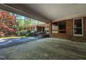 Spacious carport featuring a covered entryway, brick accents, and adjacent landscaping at 206 Rochelle Dr, Knightdale, NC 27545