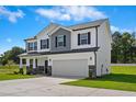Well-maintained two-story home featuring a two-car garage, stone accents, and a well-manicured lawn at 21 Green Links Dr, Cameron, NC 28326