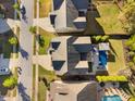An aerial view shows the home, neighboring properties, and community streets at 212 Blue Granite Dr, Holly Springs, NC 27540